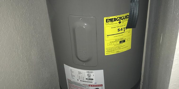 Electric tank water heater with its EnergyGuide and rating labels